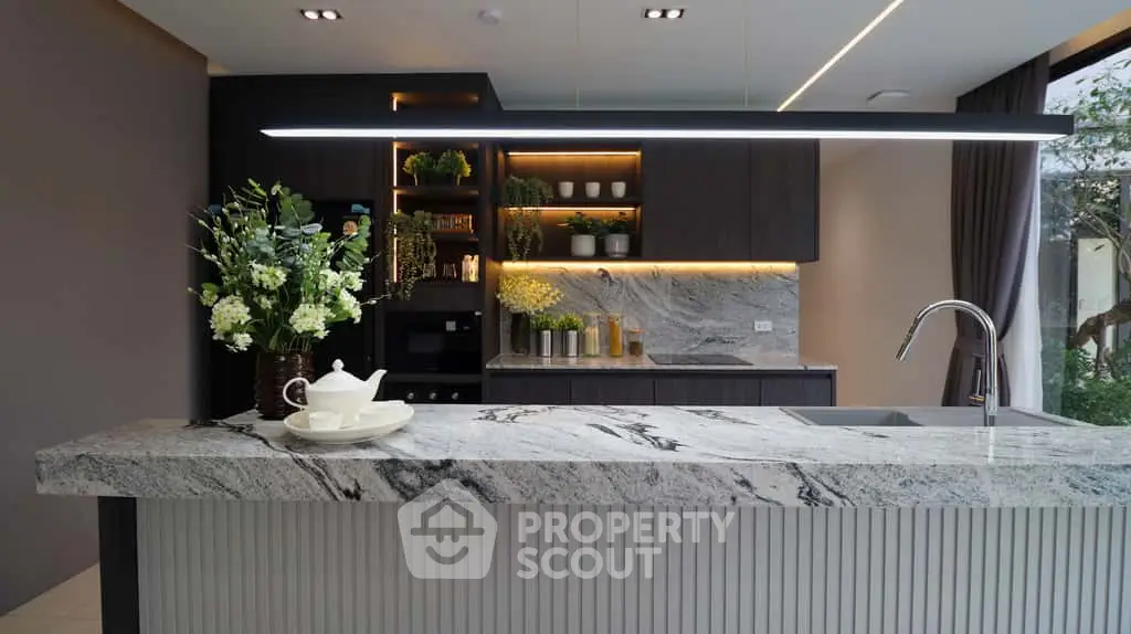 Luxurious modern kitchen with marble countertops and elegant lighting