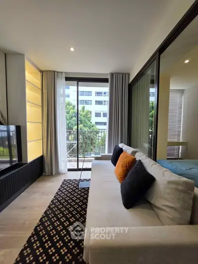 Modern living room with cozy sofa, stylish decor, and balcony view in a contemporary apartment.