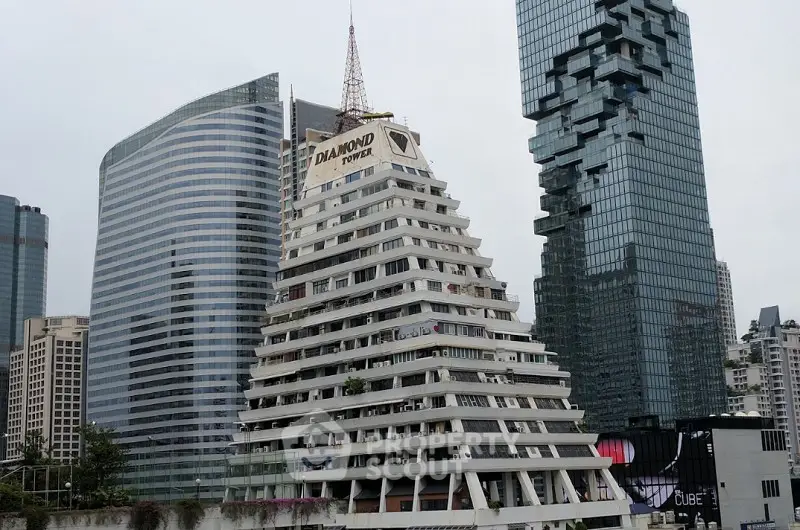 Iconic pyramid-shaped building in urban skyline with modern skyscrapers