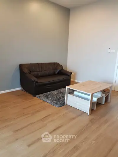 Cozy living room with modern sofa and wooden coffee table on stylish flooring.
