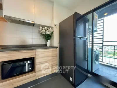 Modern kitchen with sleek appliances and balcony view