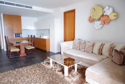 Spacious living room with modern kitchen and stylish decor in a contemporary apartment.