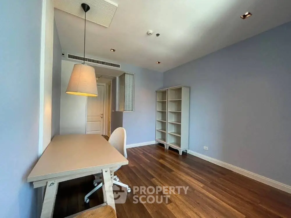 Spacious study room with wooden flooring and modern furniture