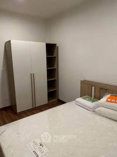Cozy bedroom with modern wardrobe and comfortable bed in a stylish apartment.