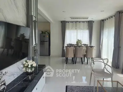 Elegant open-plan living and dining area with modern decor and natural light.