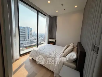 Modern bedroom with city view and large windows in high-rise apartment