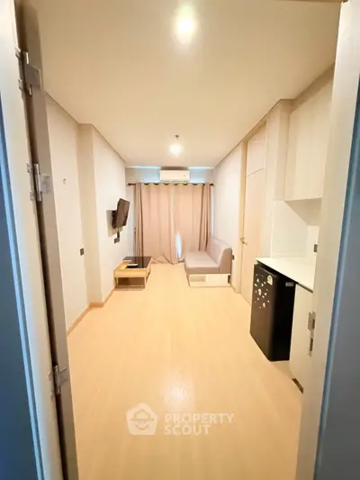 Modern living room with sleek design and compact furniture in a cozy apartment.