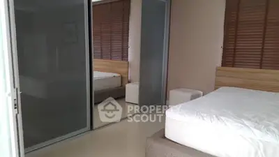 Modern bedroom with mirrored sliding closet doors and minimalist decor