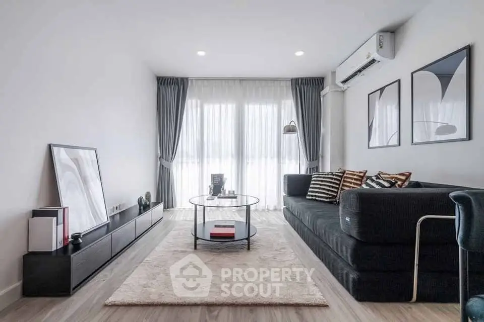 Modern living room with sleek furniture and large windows, perfect for stylish urban living.
