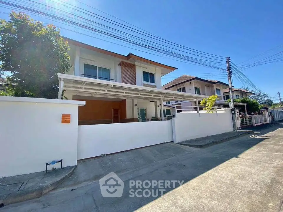 Modern two-story house with spacious driveway and clear blue sky