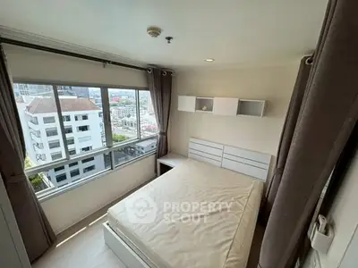 Bright bedroom with city view and modern furnishings