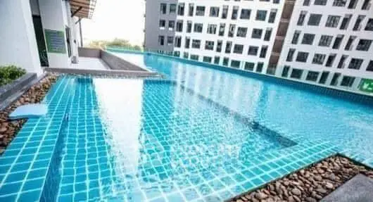 Luxurious rooftop infinity pool with stunning city views in modern apartment complex.