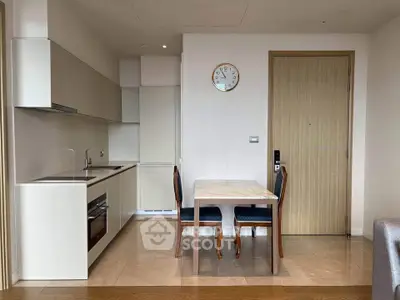 Modern kitchen with dining area featuring sleek cabinetry and elegant dining table, perfect for urban living.