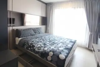 Modern bedroom with stylish decor and large window for natural light