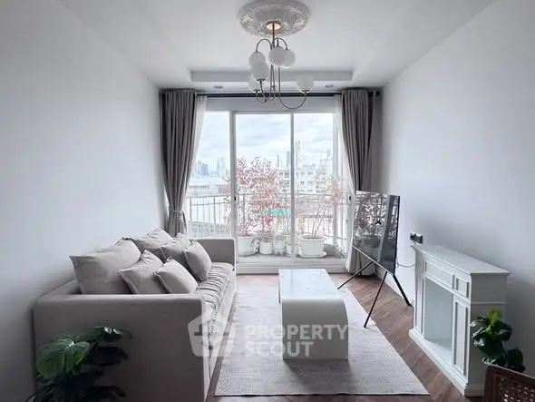 Chic living room with modern decor and city view balcony, perfect for urban living.