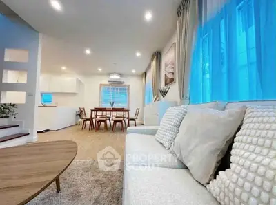 Spacious modern living room with cozy seating and open dining area
