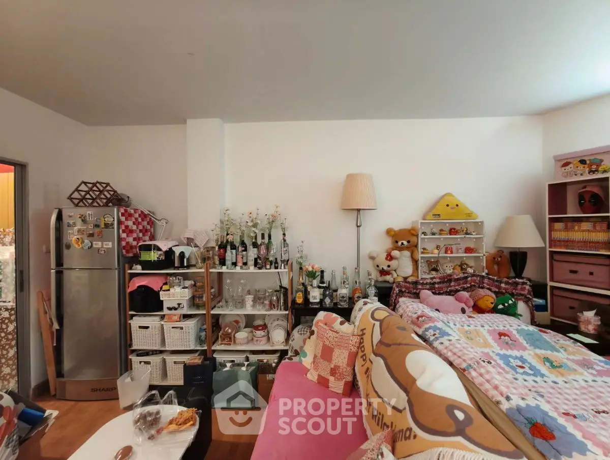 Cozy living room with eclectic decor and ample storage space.