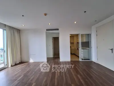 Spacious modern living room with wooden flooring and open kitchen layout