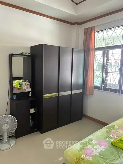 Cozy bedroom with modern wardrobe and natural light