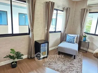 Cozy corner with stylish armchair and mini fridge in modern living room.