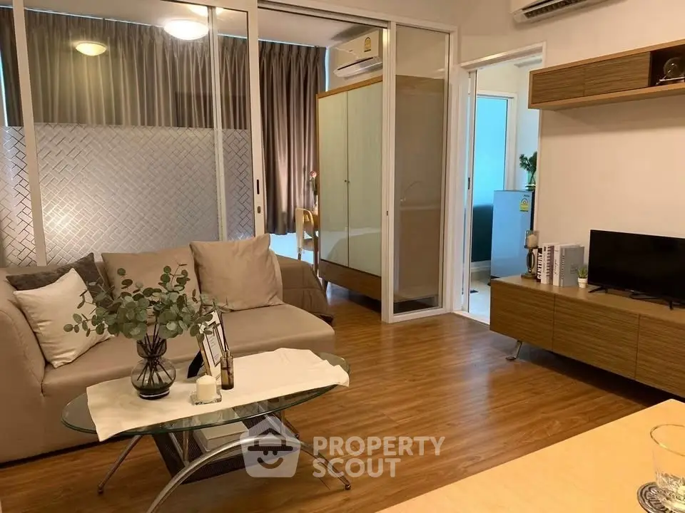 Modern living room with cozy sofa and stylish decor in a contemporary apartment.
