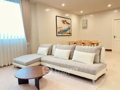 Spacious modern living room with elegant decor and cozy seating area.