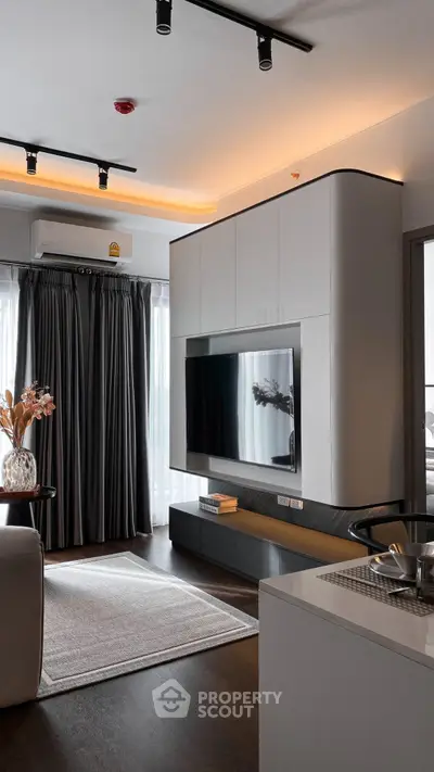 Modern living room with sleek design, large TV, and stylish lighting