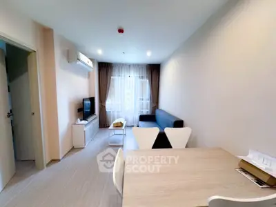 Modern living room with sleek furniture and natural light, perfect for relaxation and entertainment.