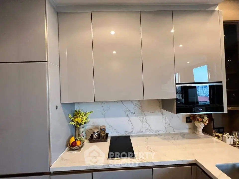 Modern kitchen with sleek cabinets and marble countertop