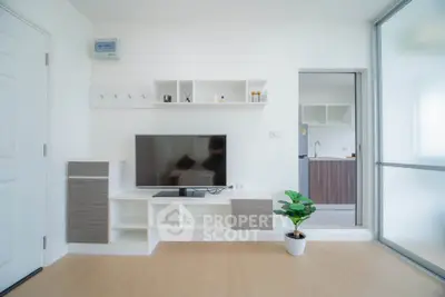 Modern living room with sleek TV unit and open kitchen view