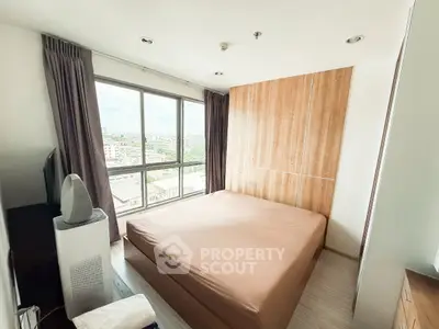 Modern bedroom with large window and city view
