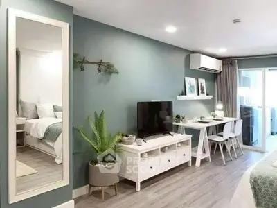 Modern living room with stylish decor, featuring a TV, desk, and large mirror, perfect for urban living.