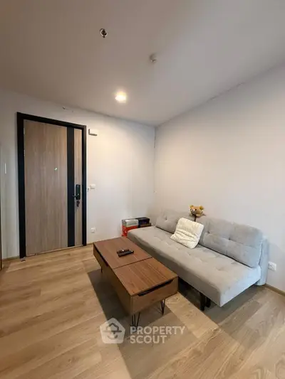 Modern living room with cozy sofa and wooden coffee table in a stylish apartment.