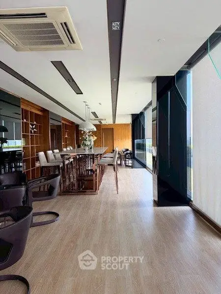 Spacious modern living room with elegant wooden flooring and large windows