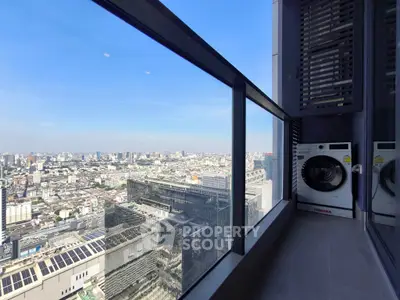 Stunning high-rise balcony view with cityscape and modern washing machine.
