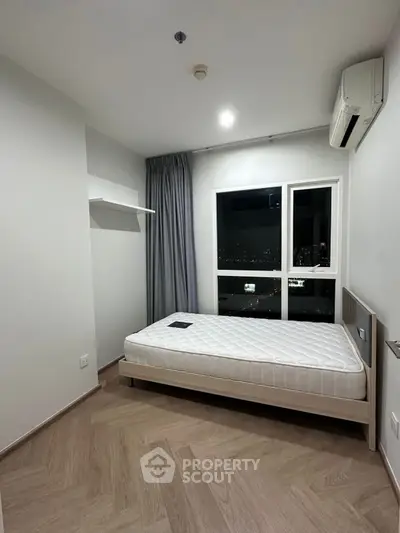 Modern minimalist bedroom with city view and air conditioning