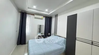 Modern bedroom with sleek design, featuring a cozy bed, wardrobe, and stylish decor.