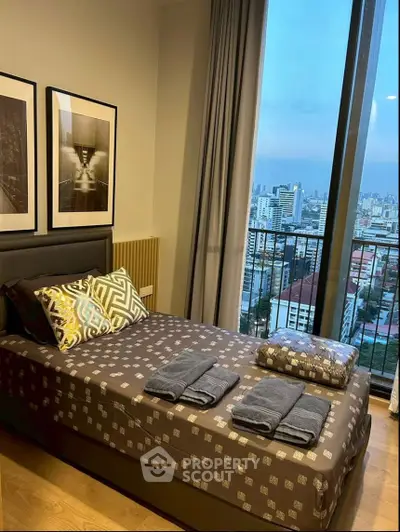Modern bedroom with city view, featuring stylish decor and floor-to-ceiling windows for a luxurious living experience.