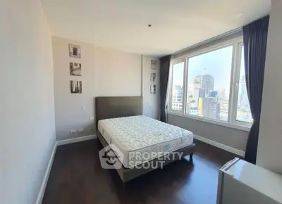 Spacious bedroom with city view in modern apartment