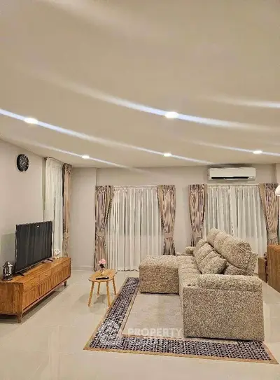 Spacious living room with modern decor and cozy seating area