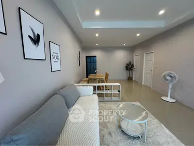 Spacious modern living room with stylish decor and cozy seating area.