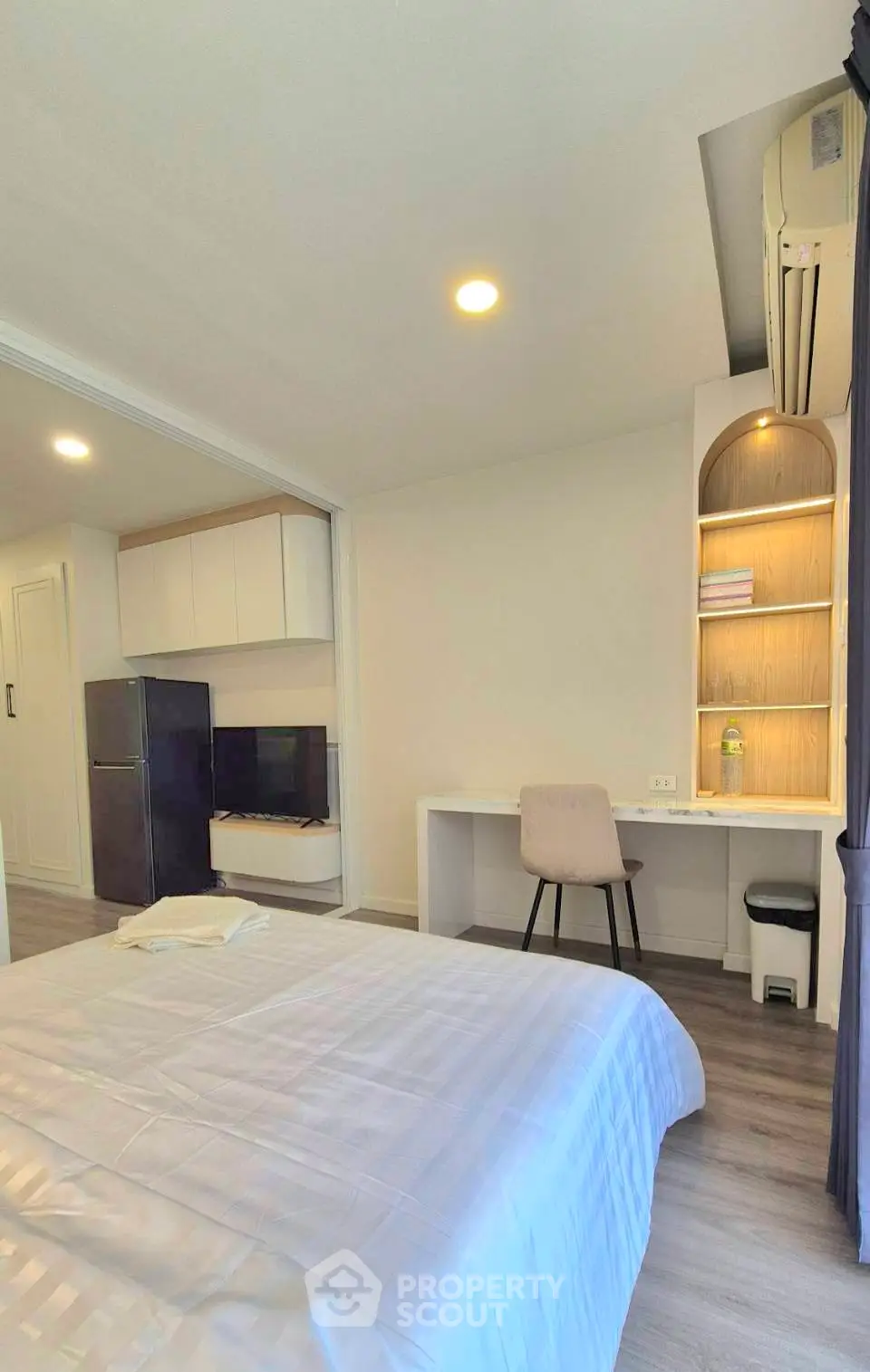 Modern bedroom with study area and sleek design in a cozy apartment.