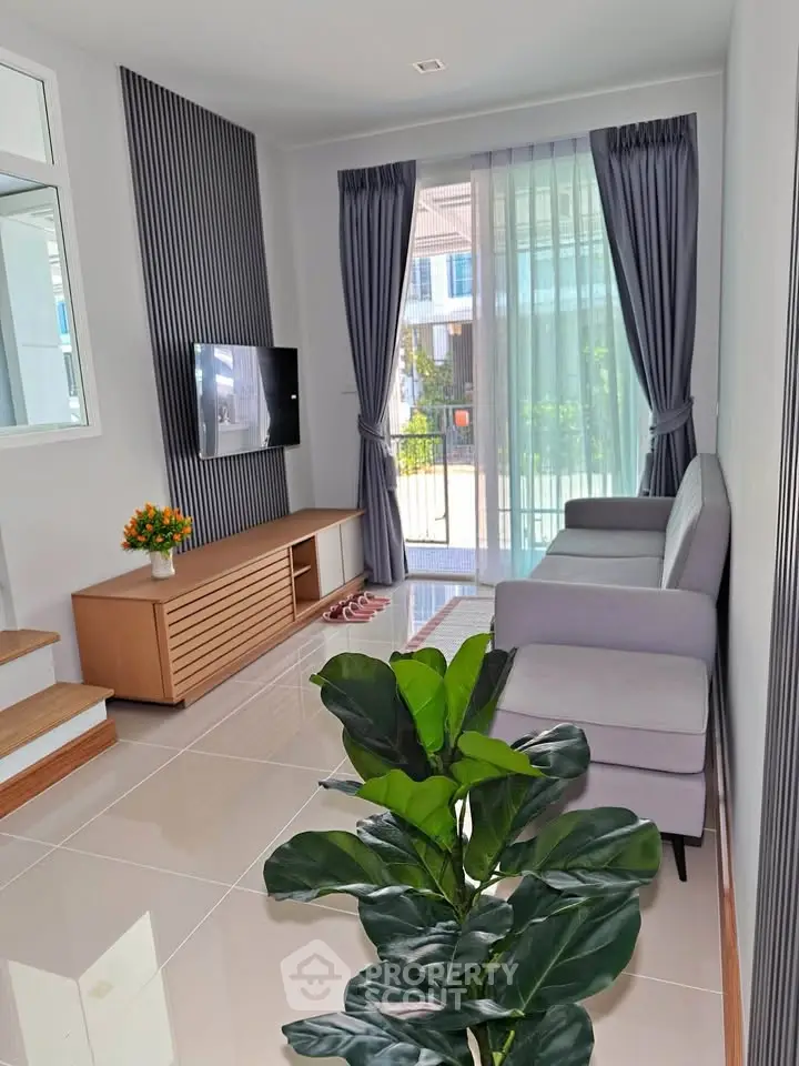 Modern living room with sleek design, large window, and stylish furniture in a contemporary home.