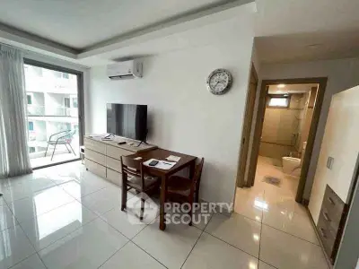 Modern living room with dining area and balcony view in a stylish apartment.