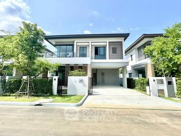 Modern two-story house with sleek design and spacious driveway in a serene neighborhood.