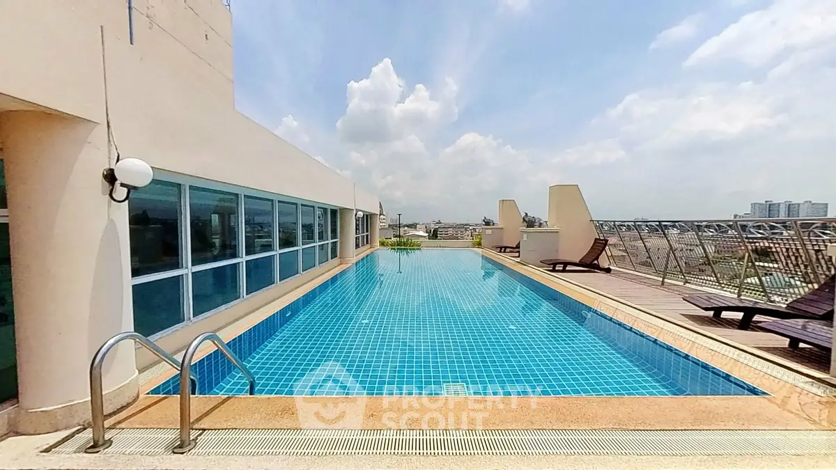 Stunning rooftop pool with panoramic city views and luxurious lounging area.