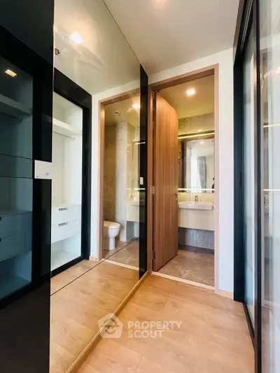 Modern bathroom with sleek design and mirrored closet doors