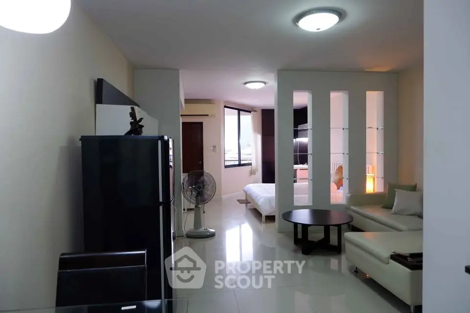 Modern open-plan living room with sleek furniture and bright lighting