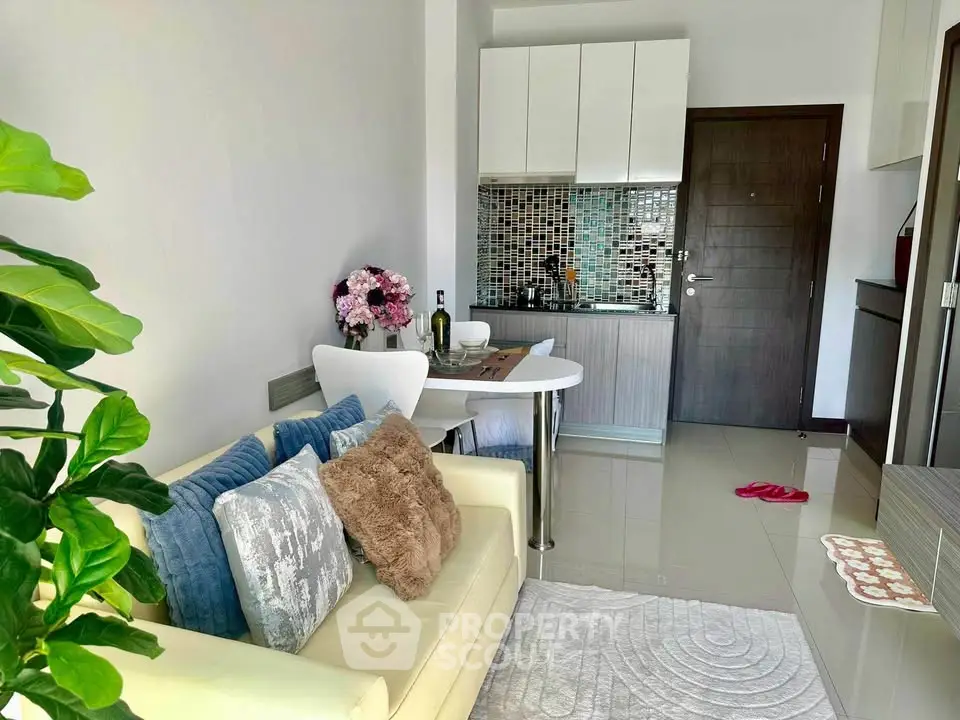 Chic modern living room with cozy sofa and stylish kitchen in open layout apartment.