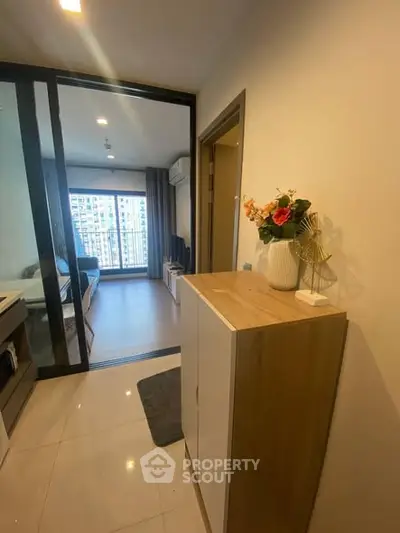 Modern apartment interior with stylish decor and city view from balcony.